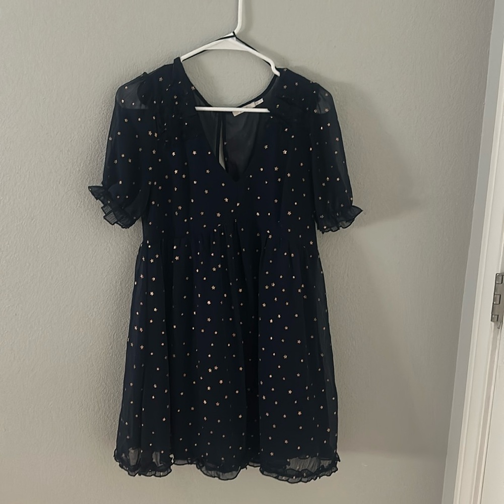 Navy blue mini dress with gold stars and ruffle details